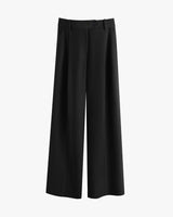 Wide-leg trousers with fitted waistband and button detail.