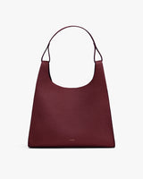 Shoulder bag with a wide strap and minimal design.