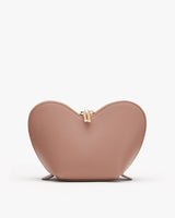 Heart-shaped purse with a clasp on a plain background.