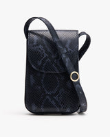 Crossbody bag with a textured surface and a circular buckle.