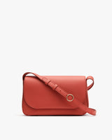 Small handbag with a long strap and a circular clasp