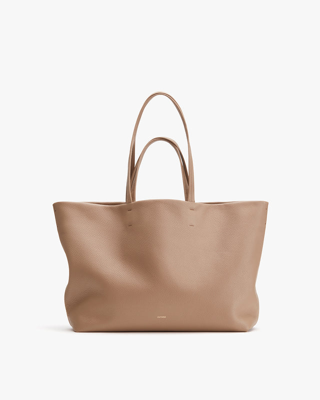Large tote bag standing upright with two handles.