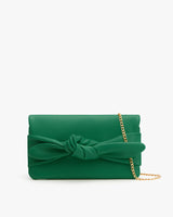 Clutch purse with a large bow and a chain strap