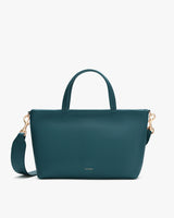 A handbag with a shoulder strap and two top handles