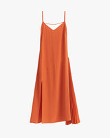Sleeveless dress with asymmetrical hem and pleated detail on one side