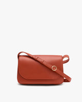 A shoulder bag with a flap and adjustable strap on a white background.