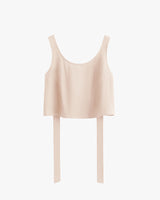 Sleeveless cropped top with overhanging long back straps.