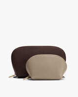 Two zipper pouches, one larger behind a smaller one.