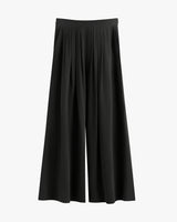Wide-leg pants with pleats on a plain background.