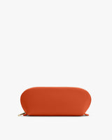 A rounded pouch with a zipper on a plain background.