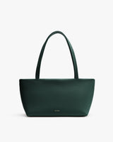 Handbag with textured surface and two handles.