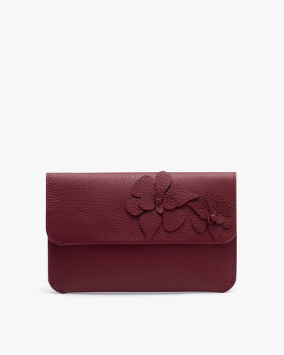 Clutch with floral details on the front flap.