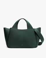 Handbag with short handles and an attached shoulder strap.
