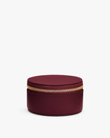 Round zippered case with smooth surface.