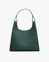 Handbag with wide strap and minimalist design.