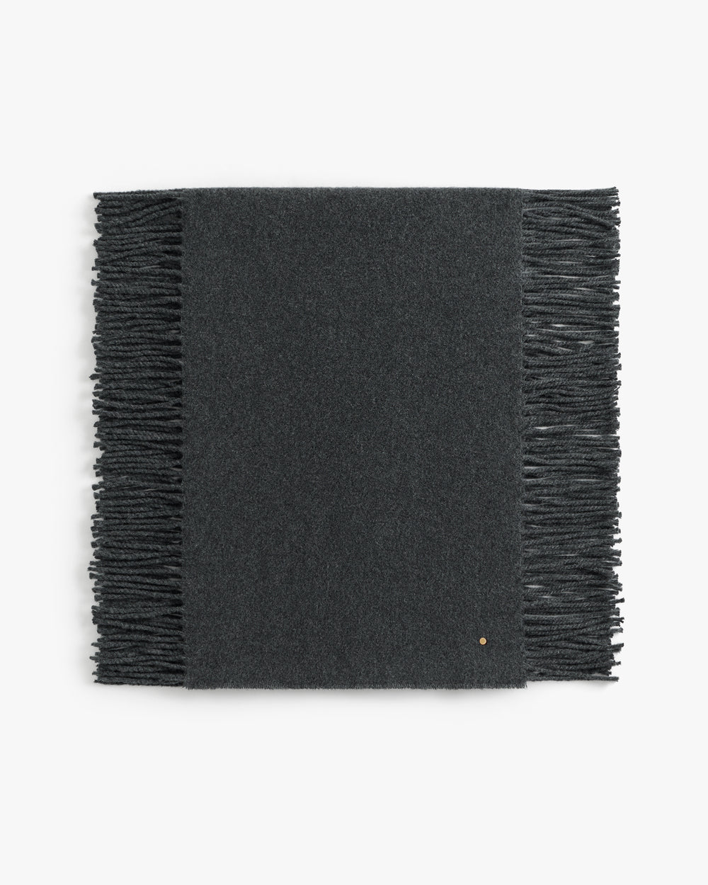 Rectangular scarf with fringed edges laid flat.