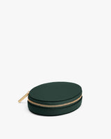 Round zippered leather pouch with gold zipper on white background
