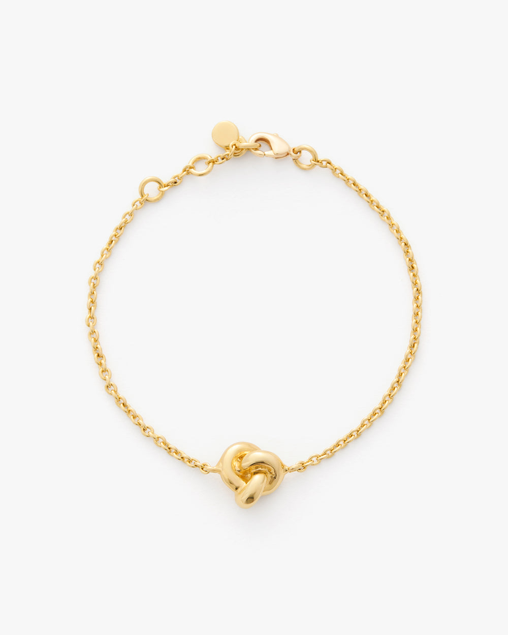 Chain bracelet with a knot detail on a plain background.