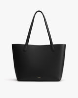 Tote bag with long handles on a plain background