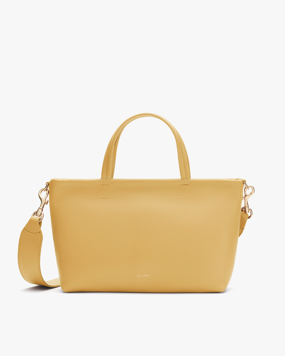 Handbag with short handles and a detachable shoulder strap placed upright.
