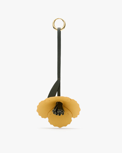 Flower-shaped keychain with a loop handle.