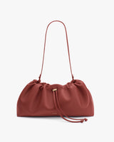 Soft shoulder bag with a ruched design and single strap.