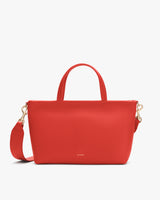 Handbag with two handles and a detachable strap.