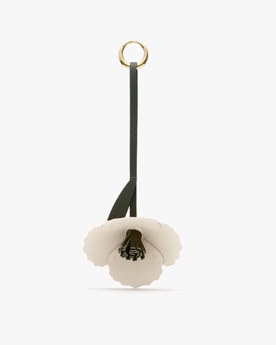 Flower-shaped keychain with a loop strap and metal ring attachment.