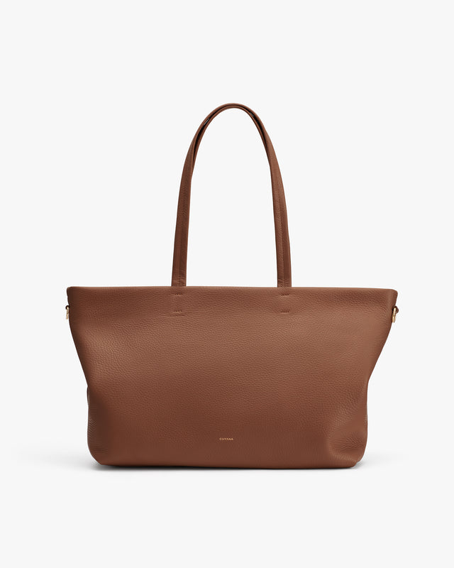 Tote bag with shoulder straps on plain background.