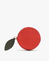 Round leather coin purse with leaf zipper pull.