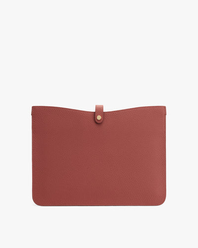 Rectangular textured leather pouch with a button closure on top.