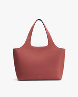 Tote bag with textured surface and wide handles against white background.