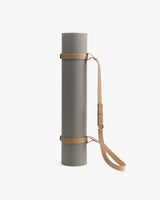 Yoga mat with strap and adjustable shoulder sling.