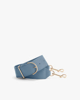 Wide belt with gold hardware and two clips on the end.