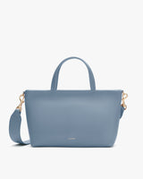 Handbag with two handles and a detachable shoulder strap.