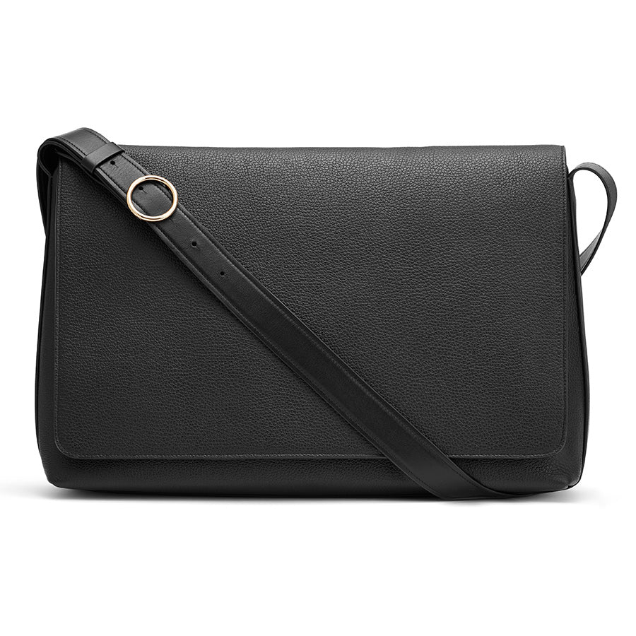 Leather shoulder bag with a crossbody strap and circular metal clasp.