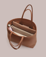 Open tote bag with a water bottle and two pouches inside