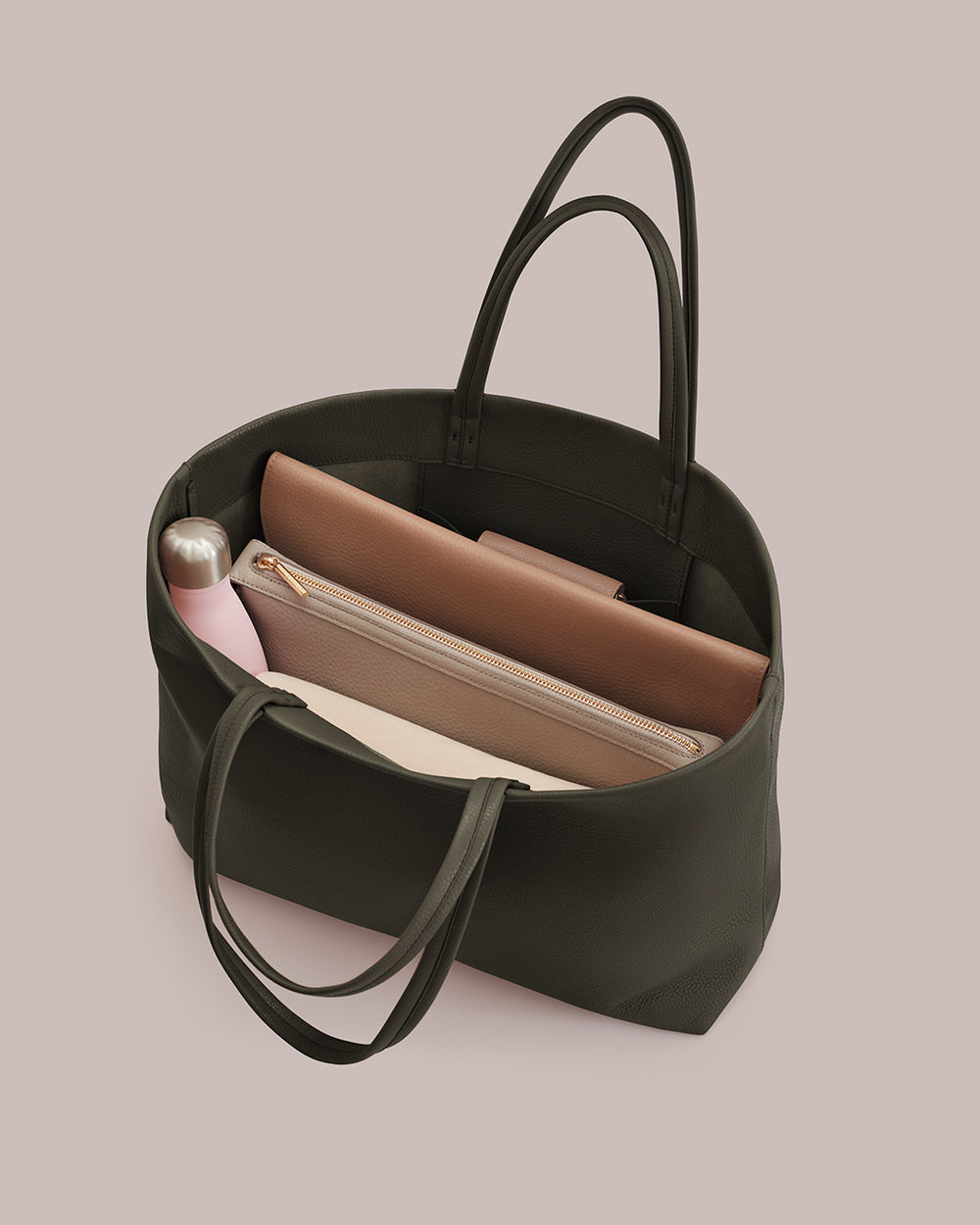 Open tote bag with a water bottle and two zipper pouches inside.