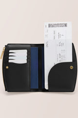 Open wallet with cards and a boarding pass inside, featuring snap closure and zipper detail.