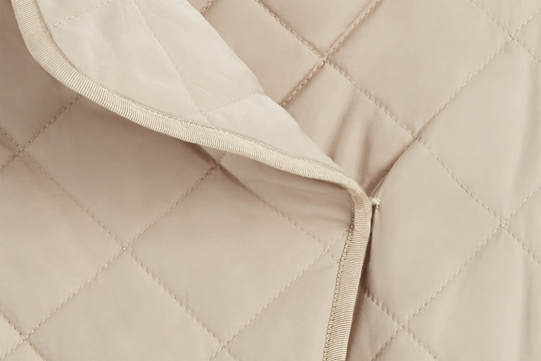 Close-up of a quilted fabric with a zipper.