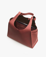 Open tote bag with interior pocket and single handle.