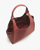 Large open-top handbag with two handles and inner pocket.