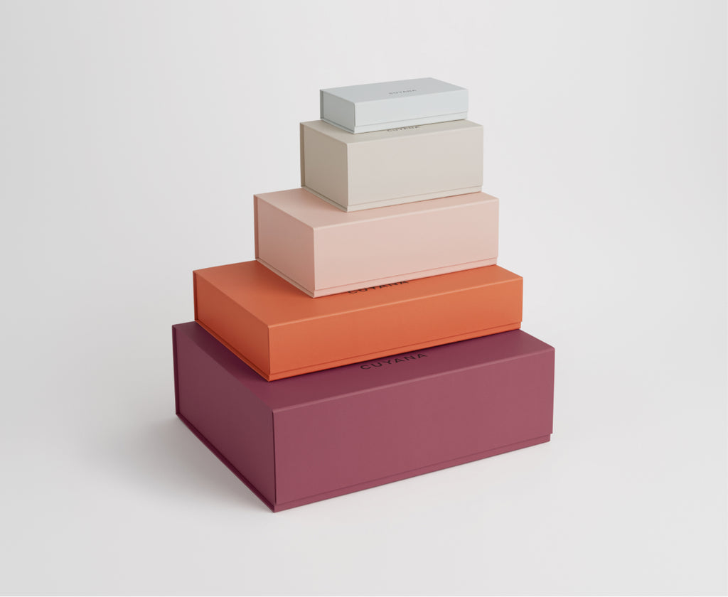 Stacked rectangular boxes in various sizes on a plain background.