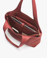 Open tote bag with organized compartments and items inside.