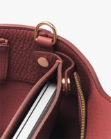 Open handbag with a visible metal clasp and a zipper compartment.