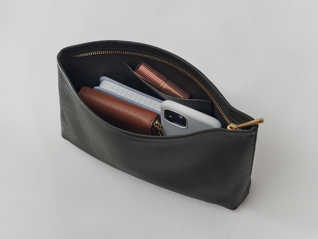 Open pouch containing various small personal items.