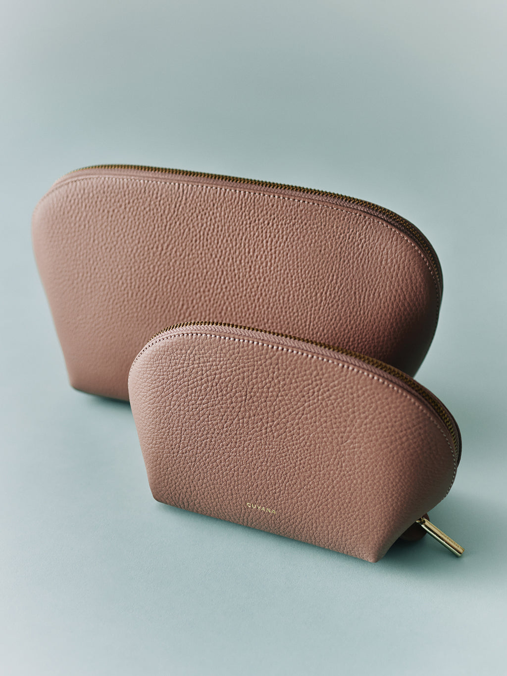 Two textured zippered pouches placed side by side.