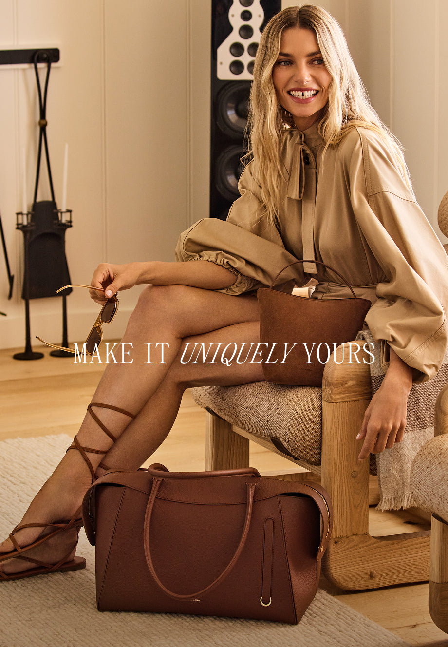 Person seated on a chair with a travel bag on the floor beside them.