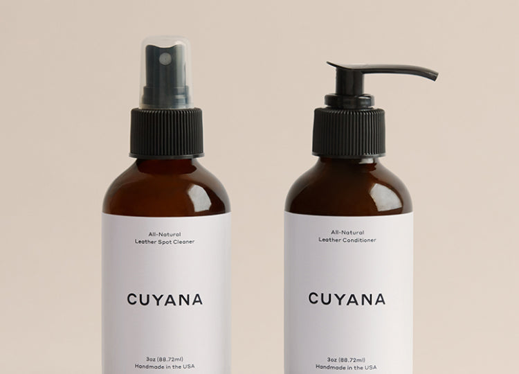 Two bottles labeled CUYANA, one with a spray nozzle and the other with a pump dispenser.