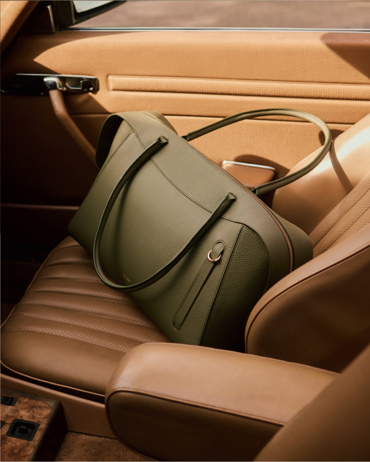 Travel bag on a car seat inside a vehicle.
